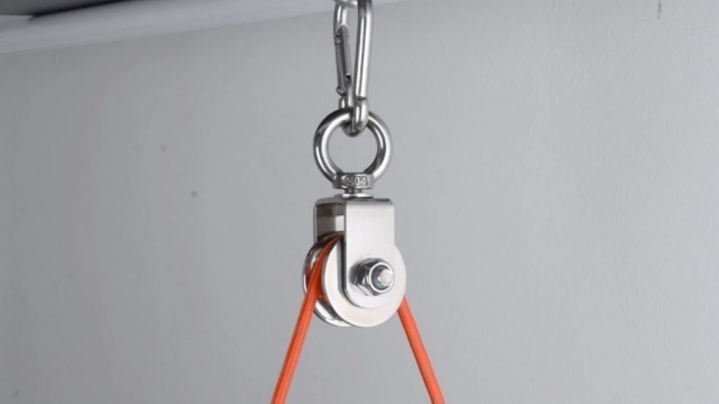 Stainless steel cable pulley wheels installed in a home gym setup.